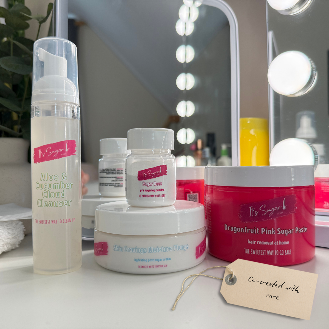 Sugar Fix Hair Removal Sugaring kit on a white dressing table with a mirror background. Hand written tag says "Co-created with care"