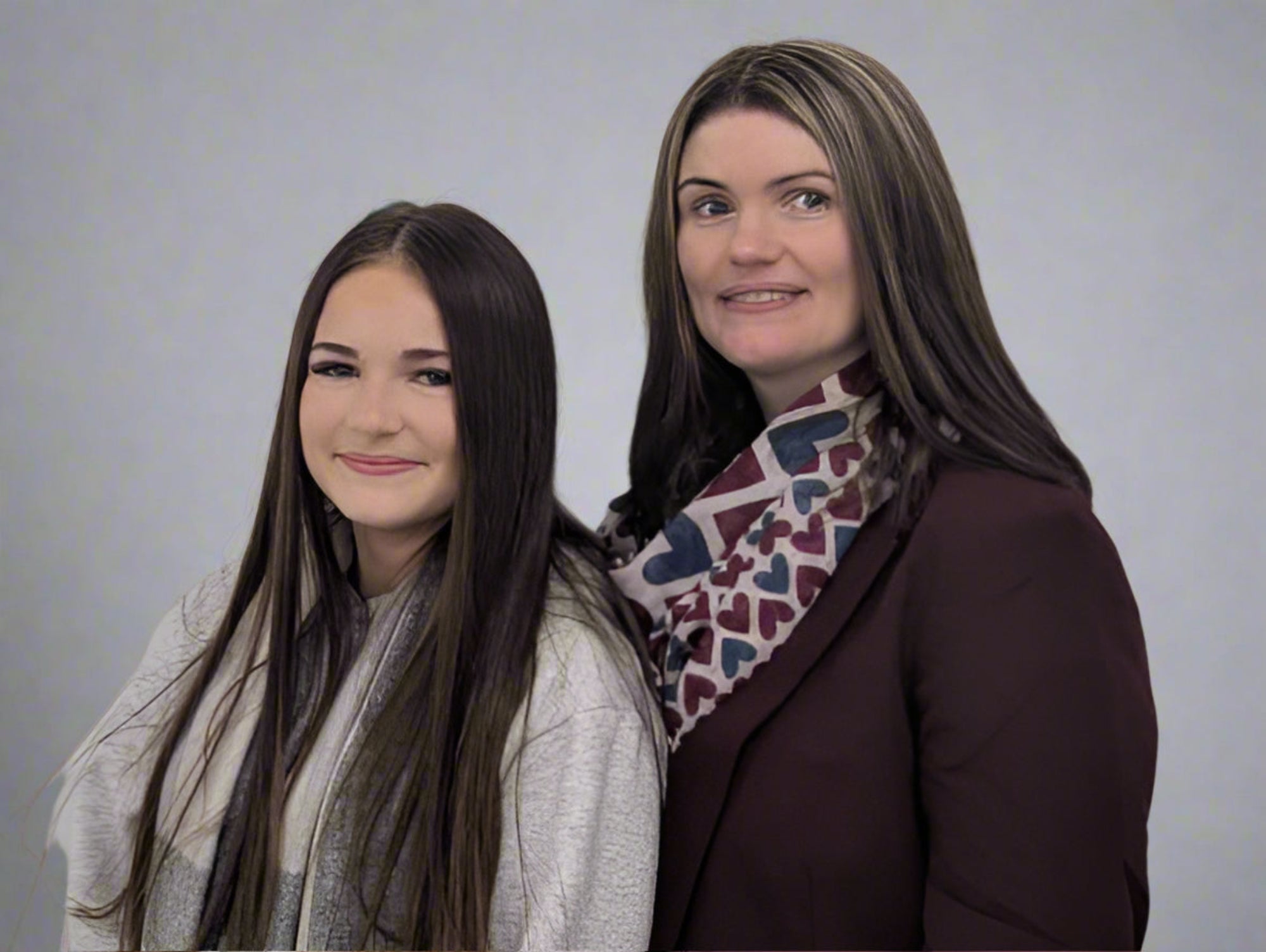 Mother & Daughter founders of It's Sugar! smiling at the camera, plain studio background