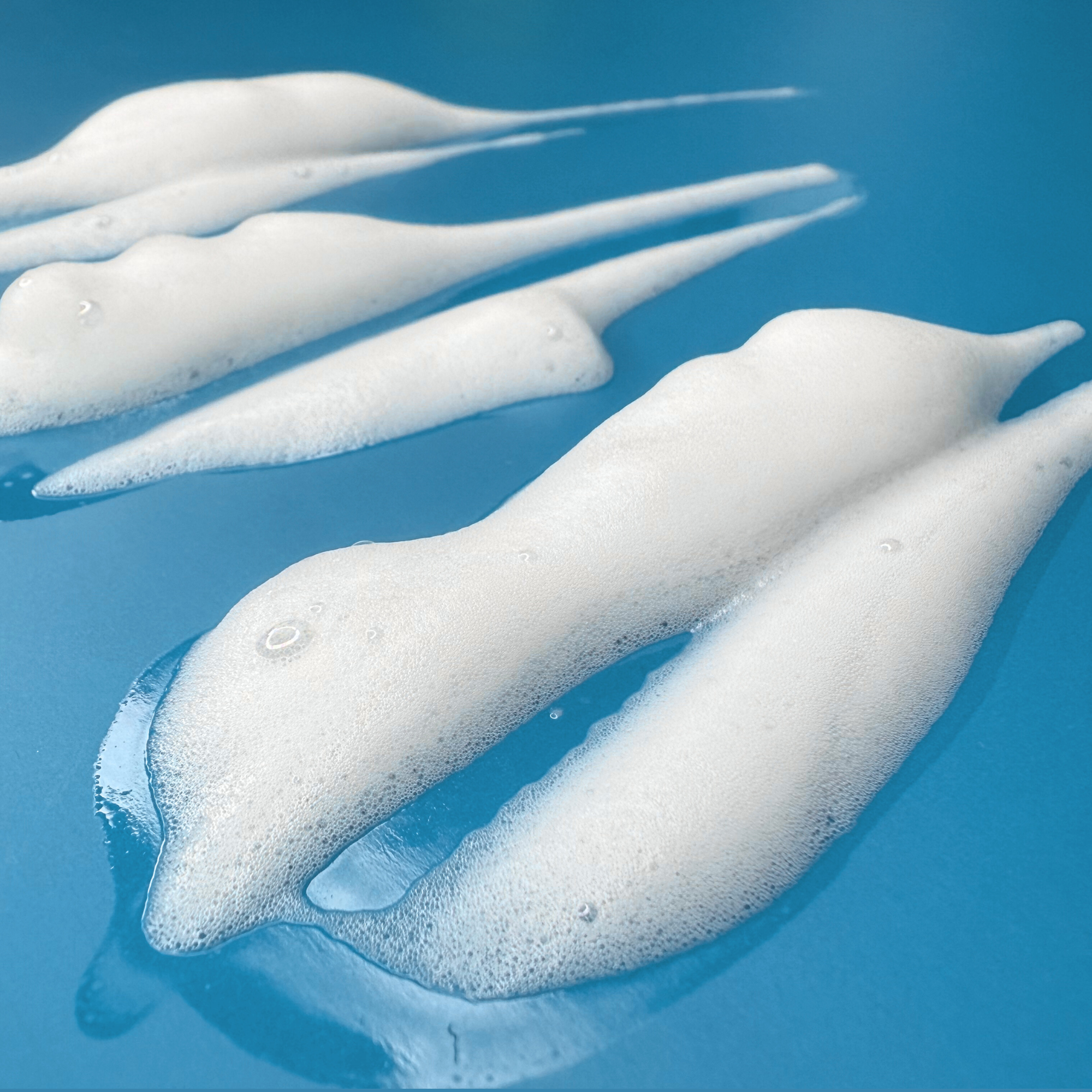 Aloe & Cucumber cloud cleanser - It's Sugar! foam swatches on a blue background