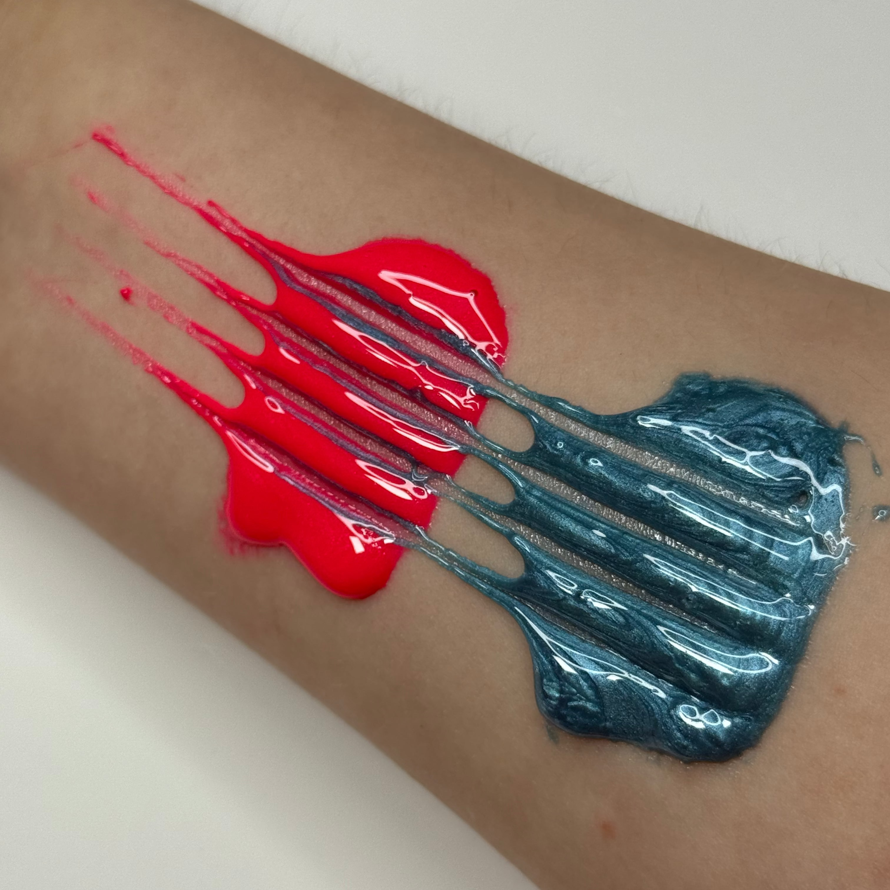 Pink and Blue Sugar Paste spread on arm with fork marks through them.